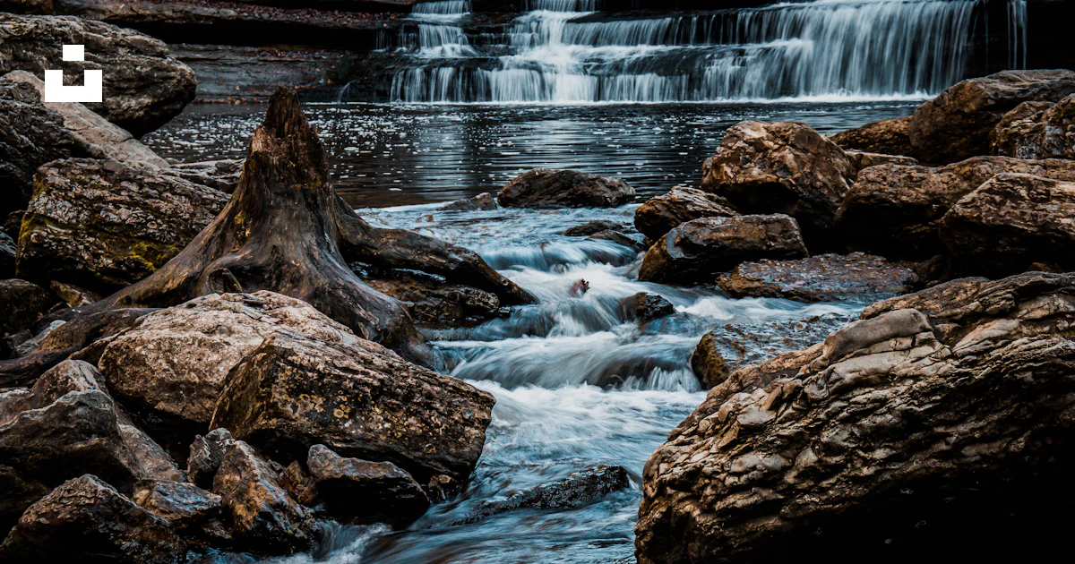 Waterfall Through Rocks A waterfall over rocks photo – Free Nature Image on Unsplash