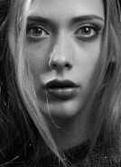 A striking black and yellow themed portrait with cinematic lighting highlighting the subject's intense gaze.