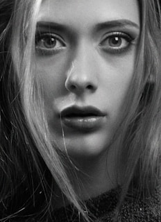 A striking black-and-white portrait of the actor, with a bold red accent highlighting his intense gaze.