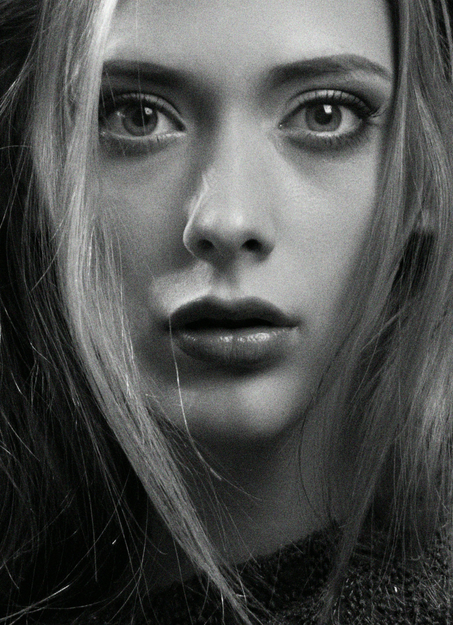 A close-up shot of an intricately framed black-and-white portrait, capturing deep emotion in the subject's eyes.