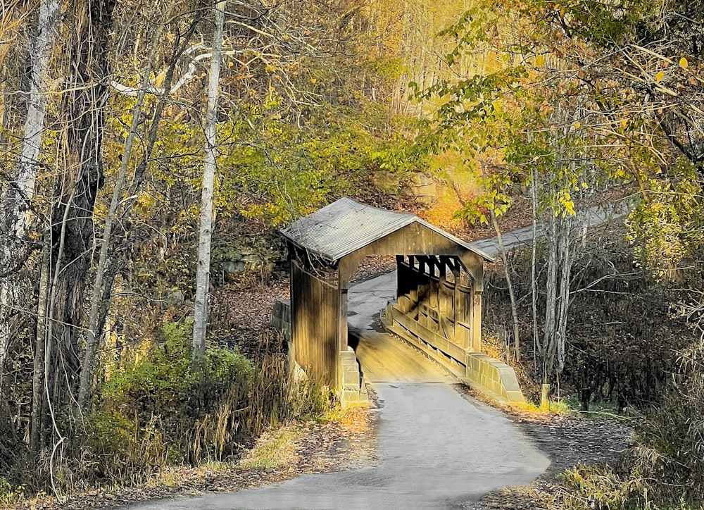 a wooden bridge over a dirt road