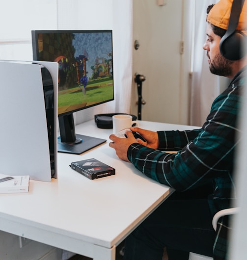 a person wearing a mask and sitting at a desk