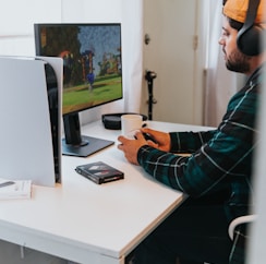 a person wearing a mask and sitting at a desk