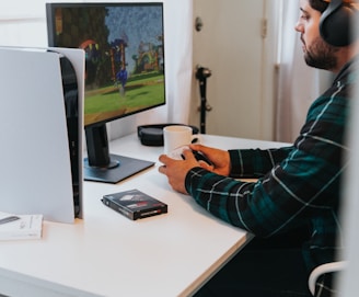 a person wearing a mask and sitting at a desk