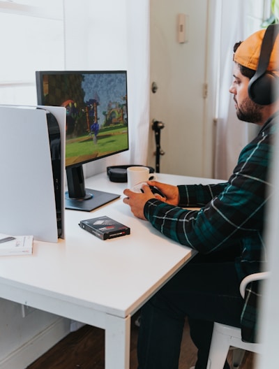 a person wearing a mask and sitting at a desk