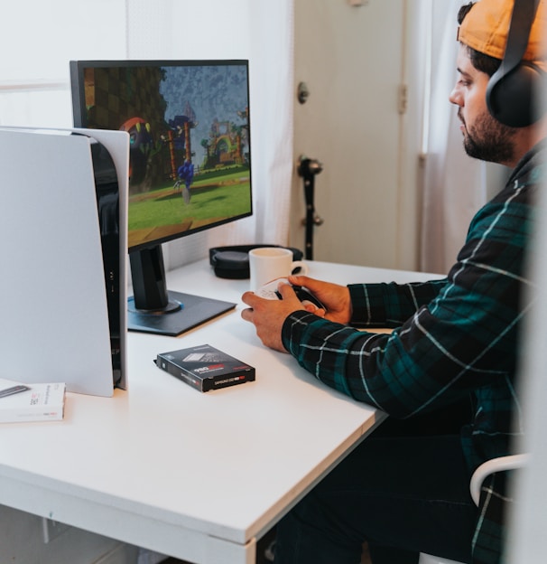 a person wearing a mask and sitting at a desk