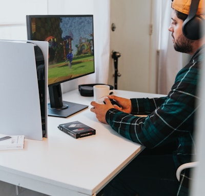 a person wearing a mask and sitting at a desk