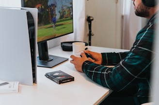 a person wearing a mask and sitting at a desk