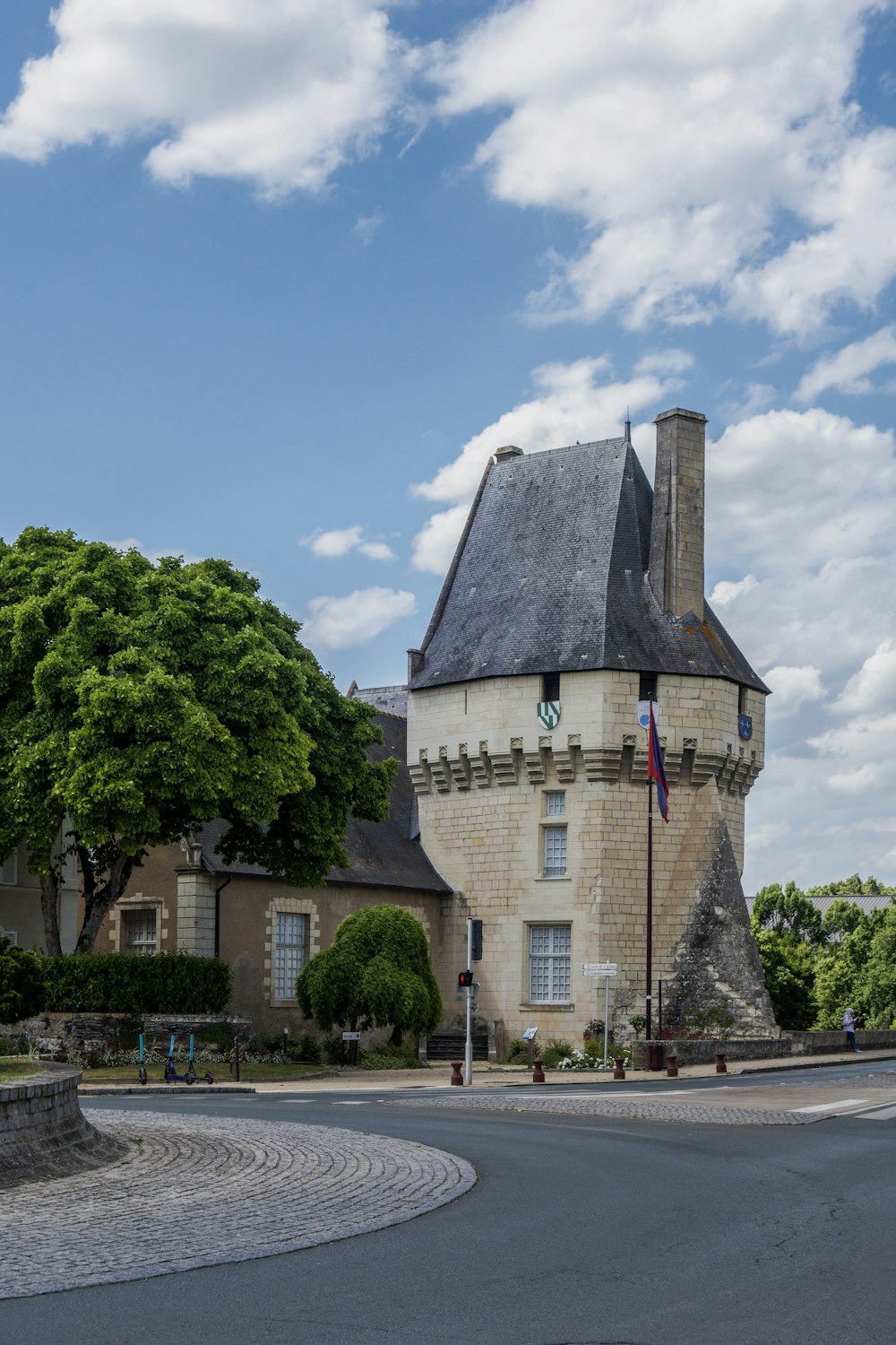 a stone building with a flag on top