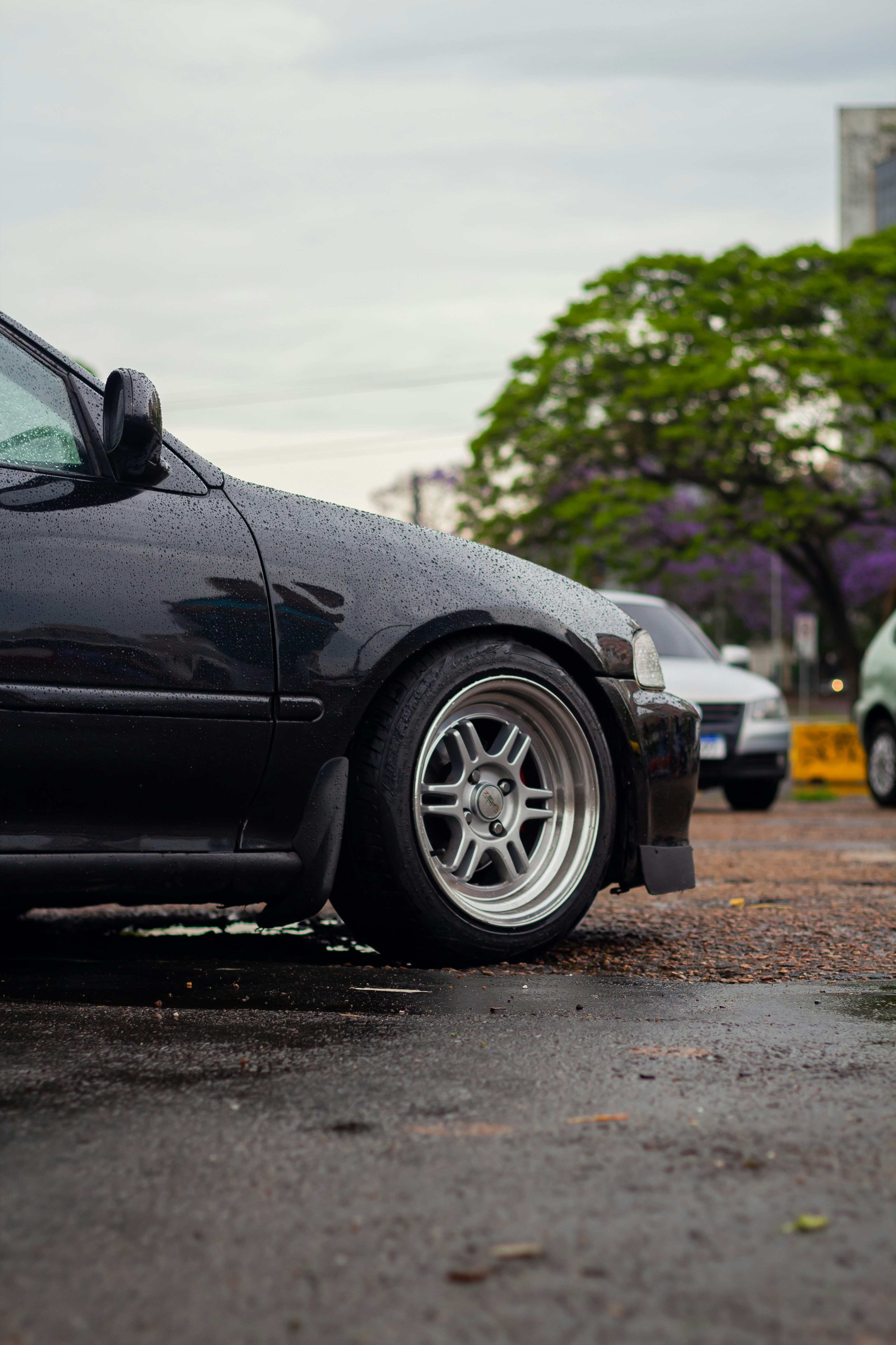 a black car with a dent in the front end