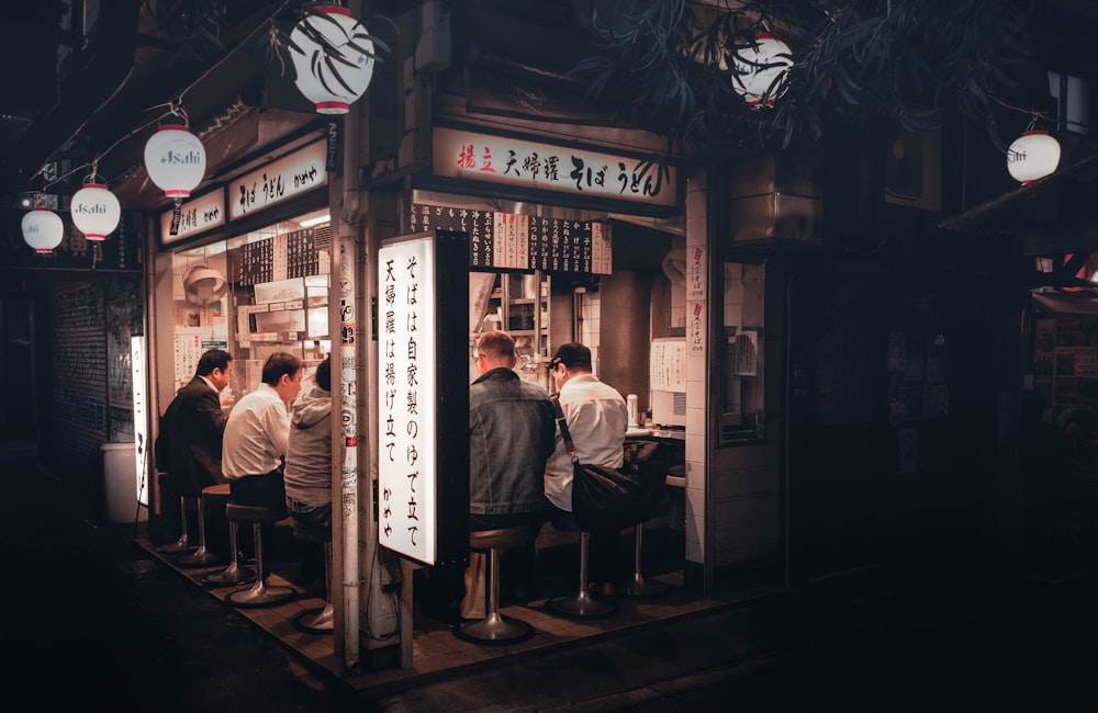 a group of people sitting outside a bar