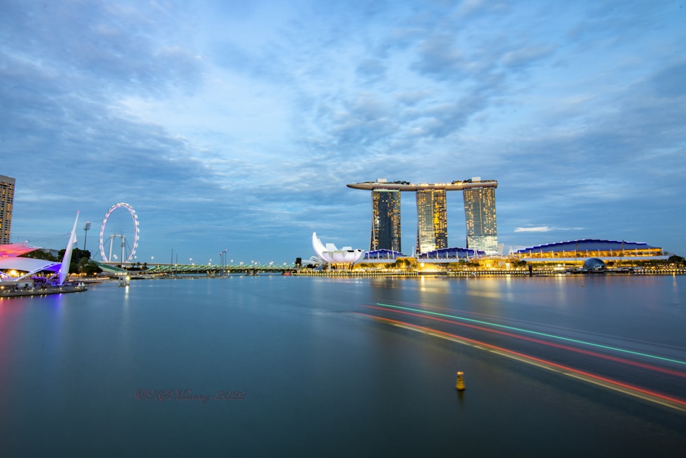 a body of water with buildings along it with Marina Bay Sands in the background