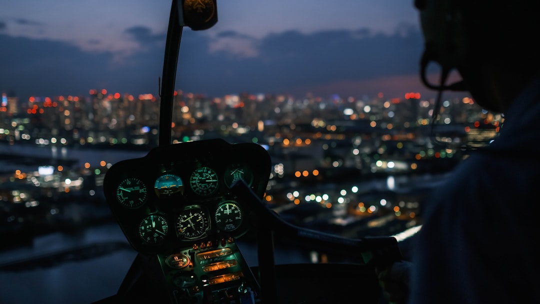 a person driving a car, Approaching Tokyo in a helicopter with the Tokyo skyline at night time