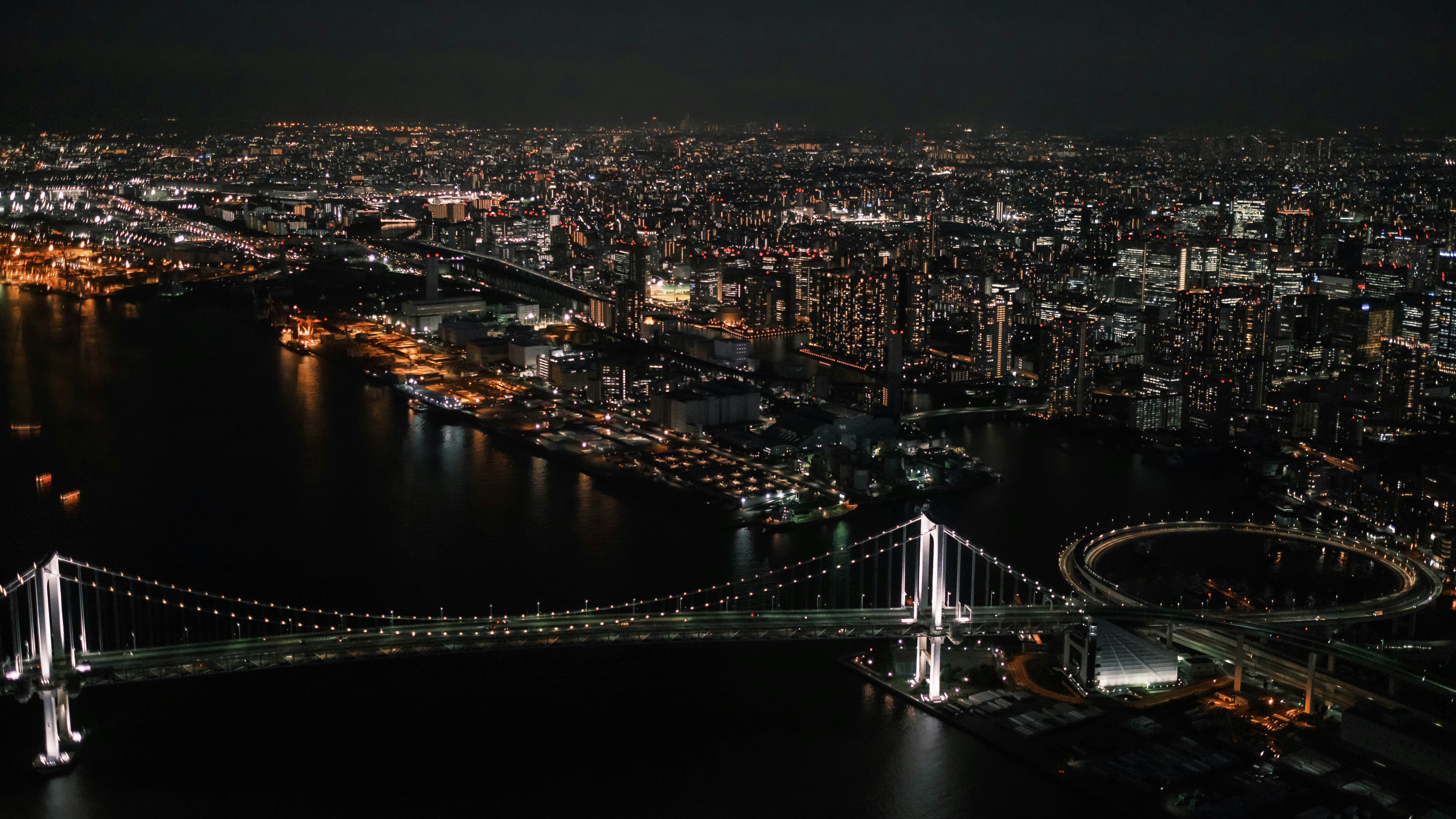 a bridge over a river in a city at night, 