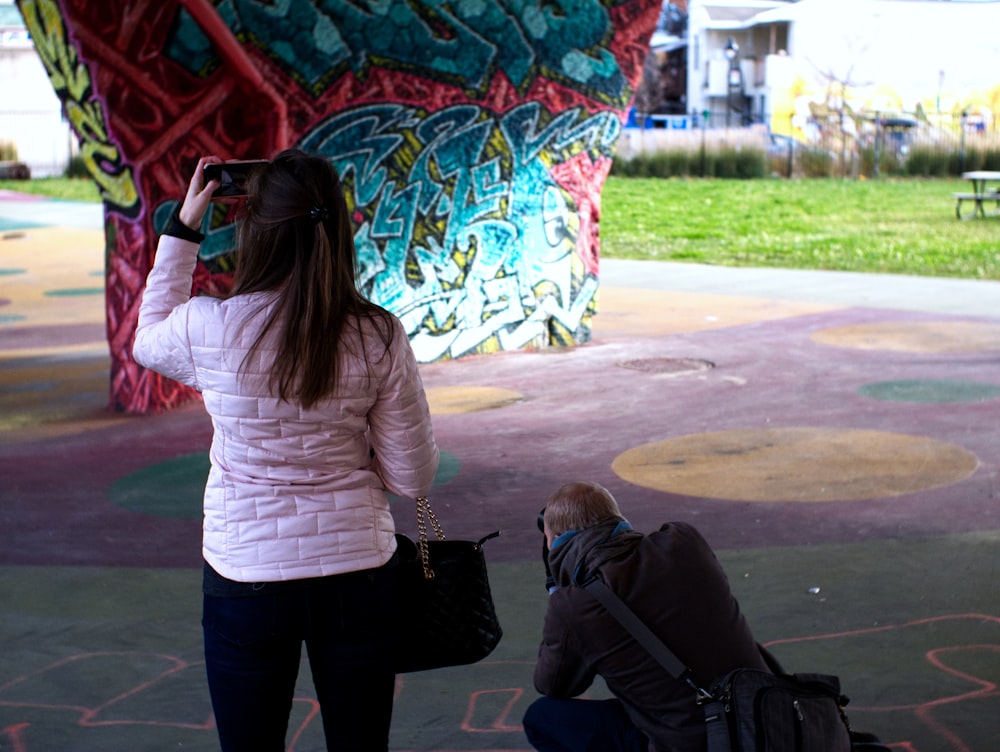 a person taking a picture of a kite