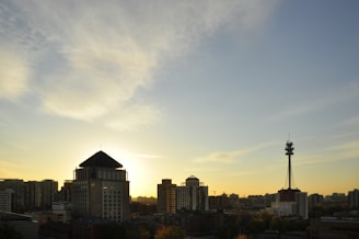 Sunset over the Atlanta skyline with the silhouette of the iconic Bank of America Plaza glowing warmly.