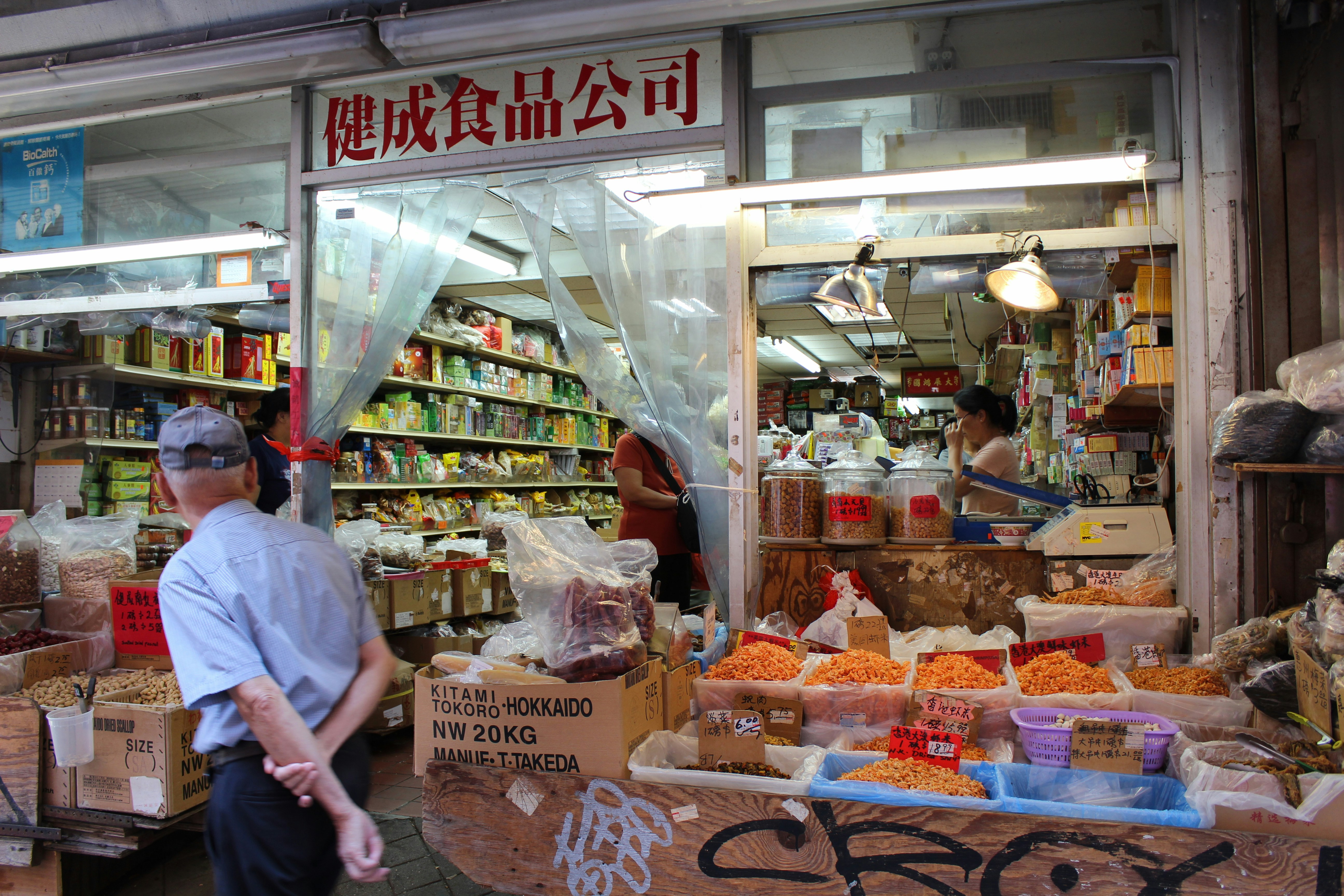 a person standing in front of a store selling food