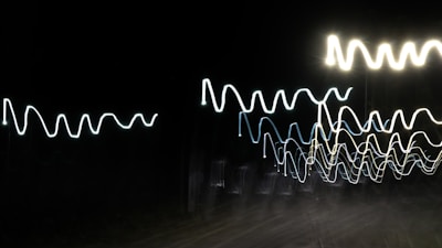 Bright glowing signal waves cutting through a dark, noisy background.