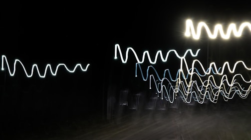 Waveforms and AI-generated patterns visualized on a computer screen.