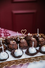 Artisan carefully decorating cake pops in a cozy kitchen setting.