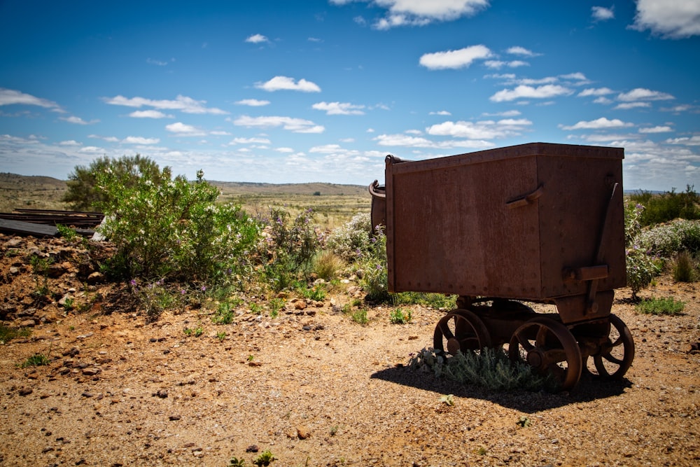 a rusty wagon on a dirt road