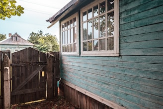 a wooden fence next to a house