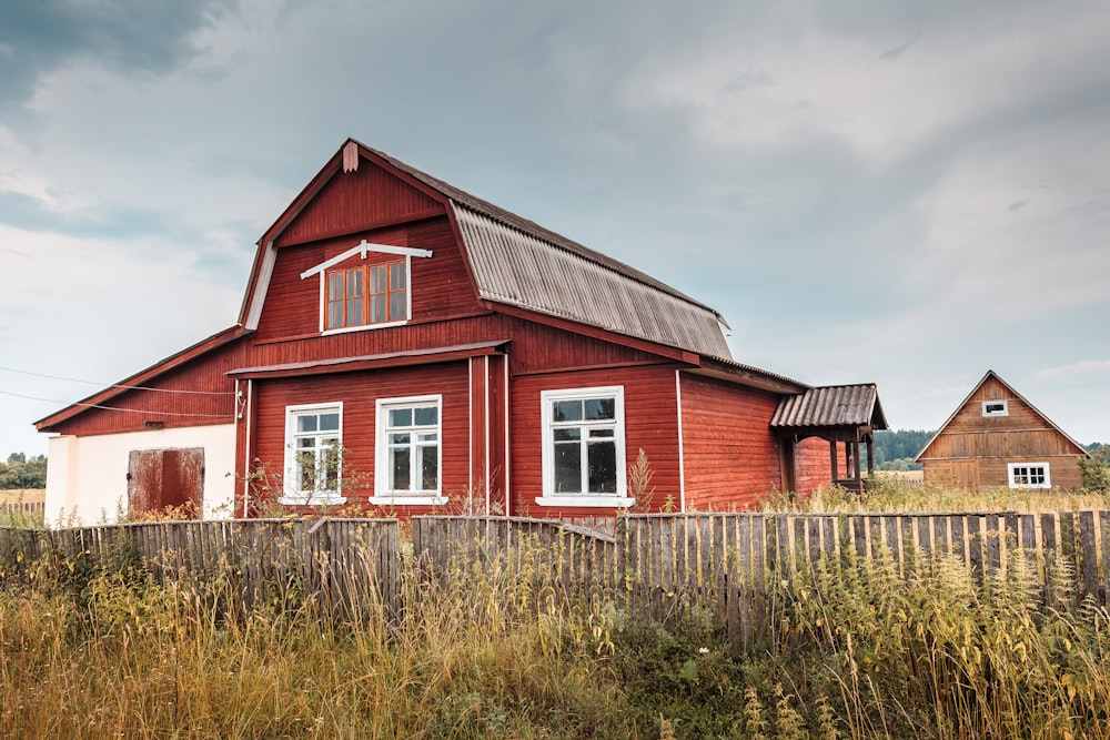 a red barn with a fence