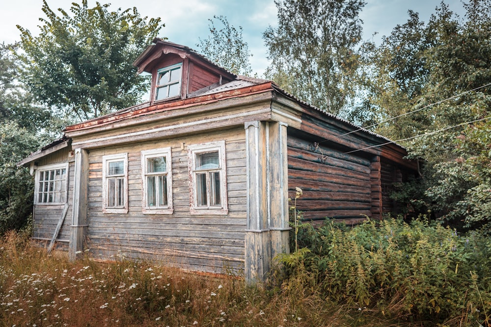 a wooden house with trees around it