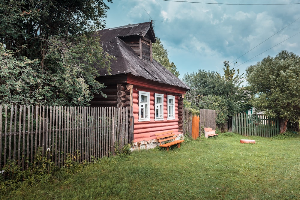 a small red house with Wilderstein in the background