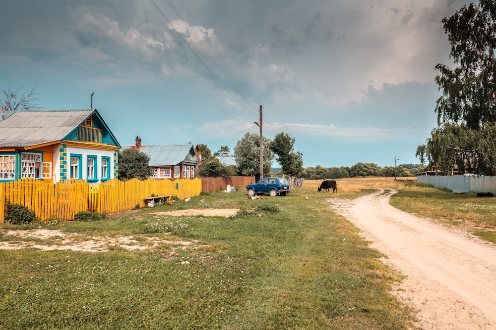 a car parked on the side of a road next to a house