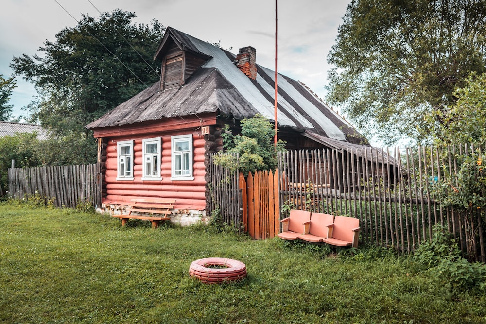 a small house with a fence