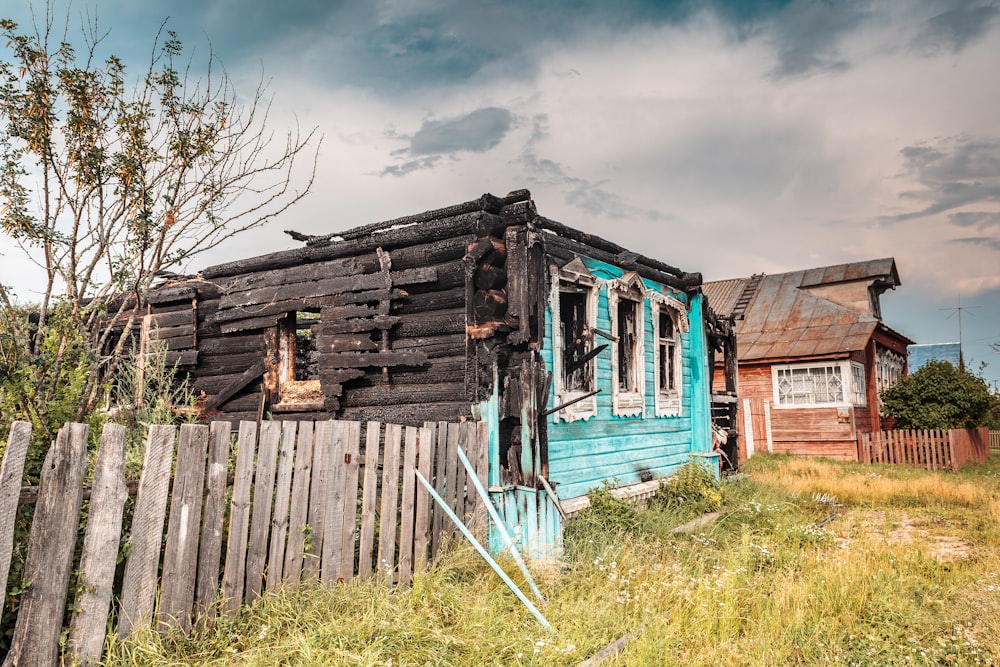 a dilapidated house in a grassy area