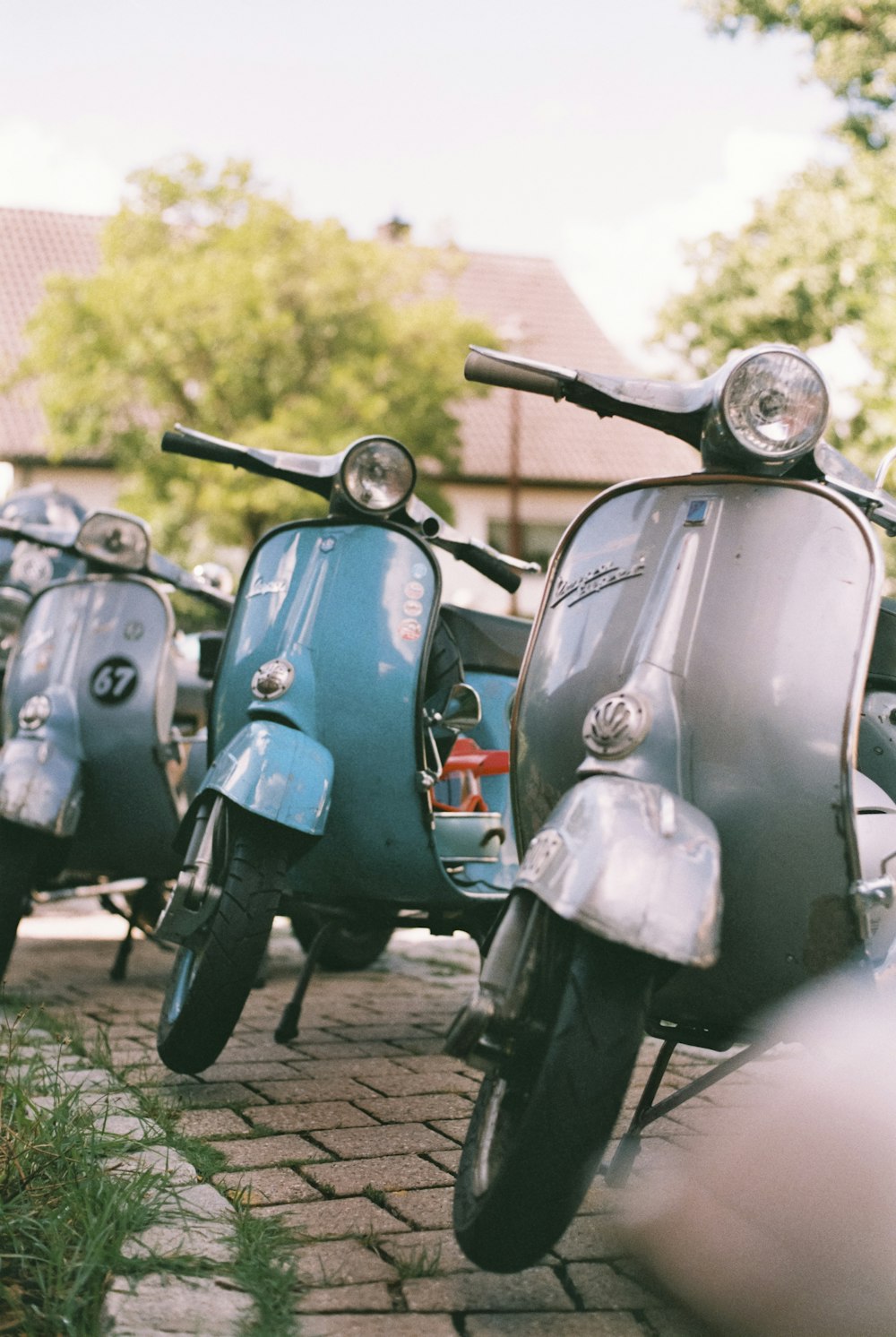 a row of motorcycles parked on a brick road