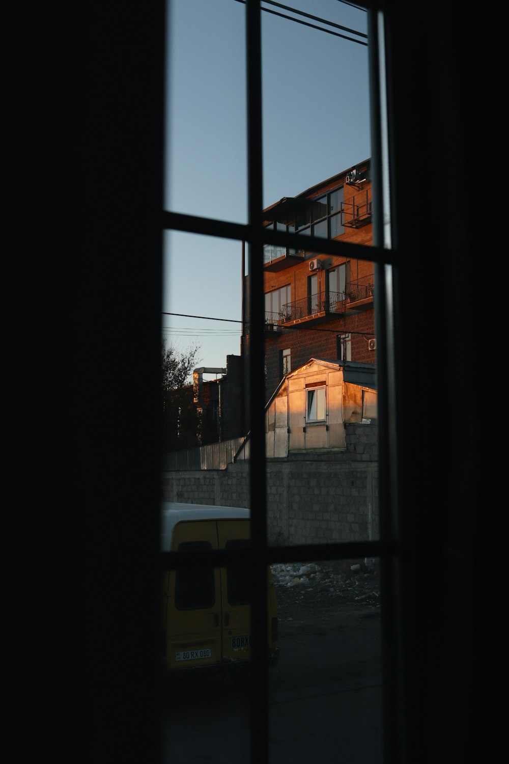 a window with a building in the background