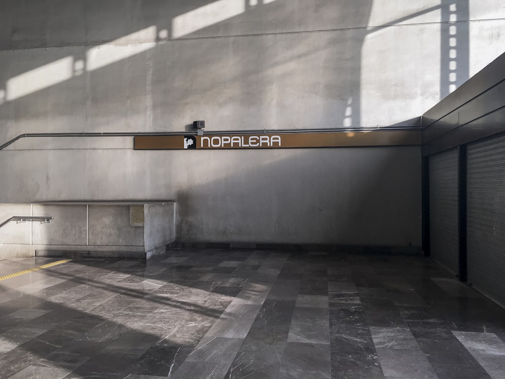 a large grey building with a sign on the wall