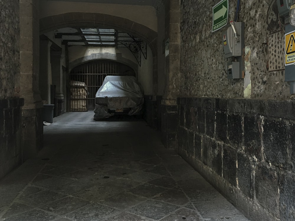 a stone alley way with a tarp over it