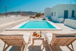 a pool and chairs on a deck