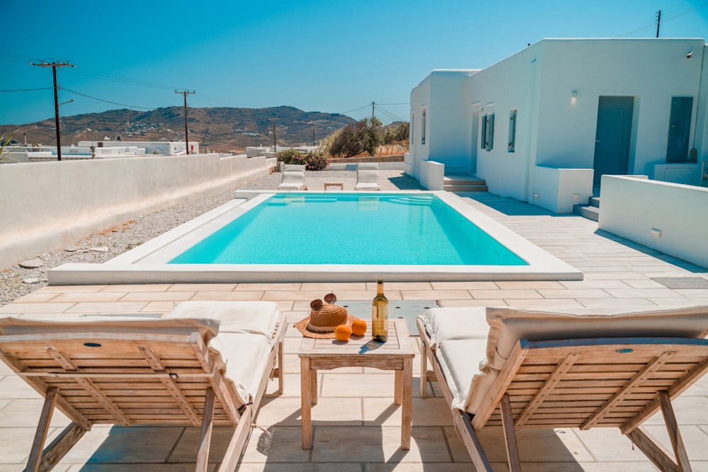 a pool and chairs on a deck