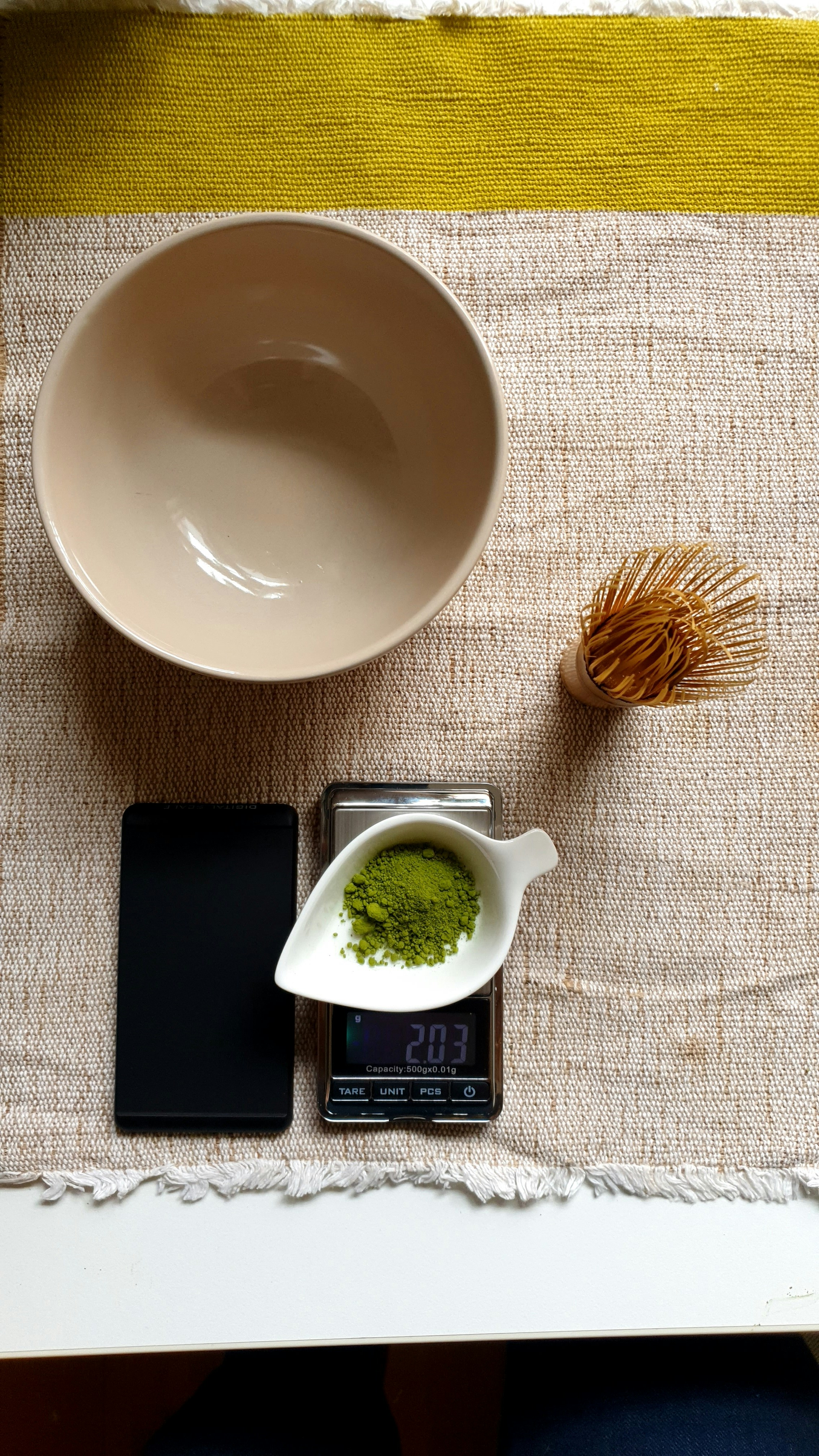 a cup of tea and a cell phone on a table