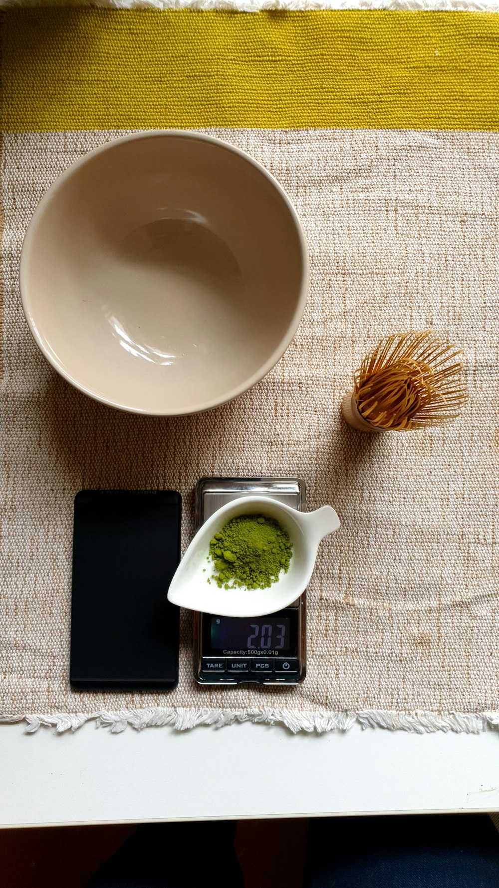 a cup of tea and a cell phone on a table