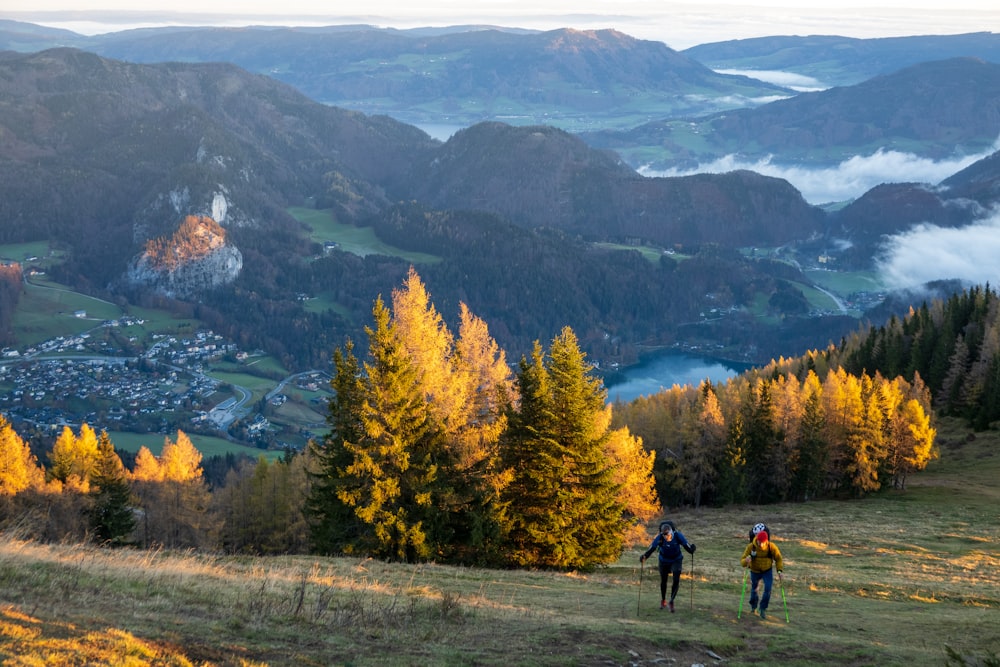 a couple people hiking in a valley