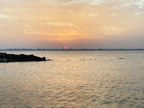 A wide shot capturing the natural beauty and calm waters of the Friedgraben at sunset.