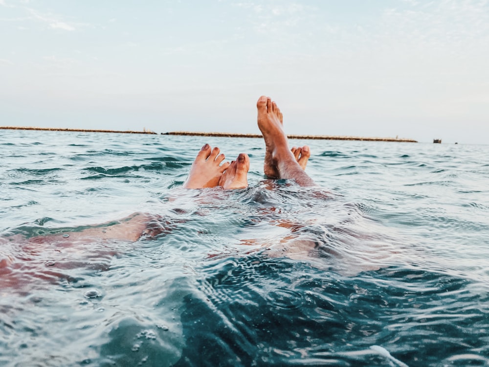 a person's feet in the water