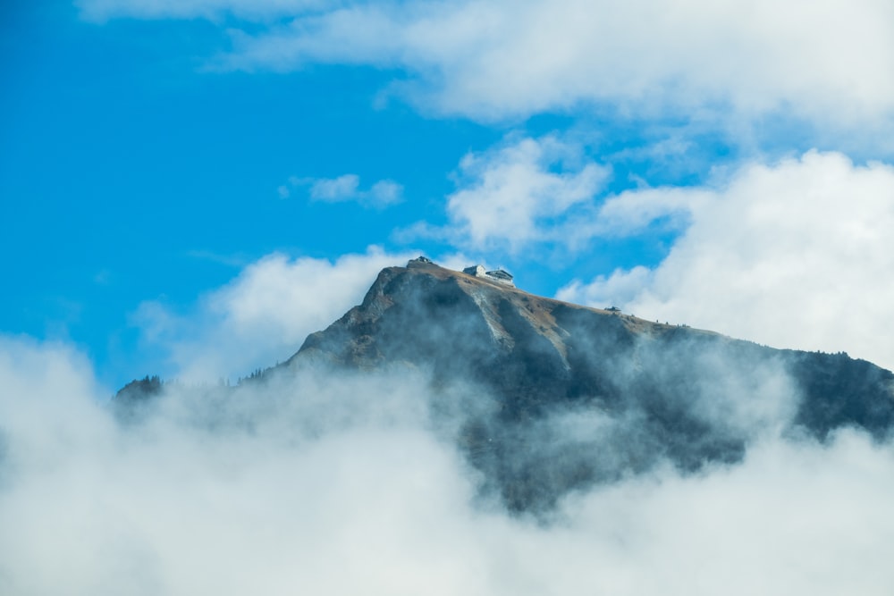 a mountain with clouds below