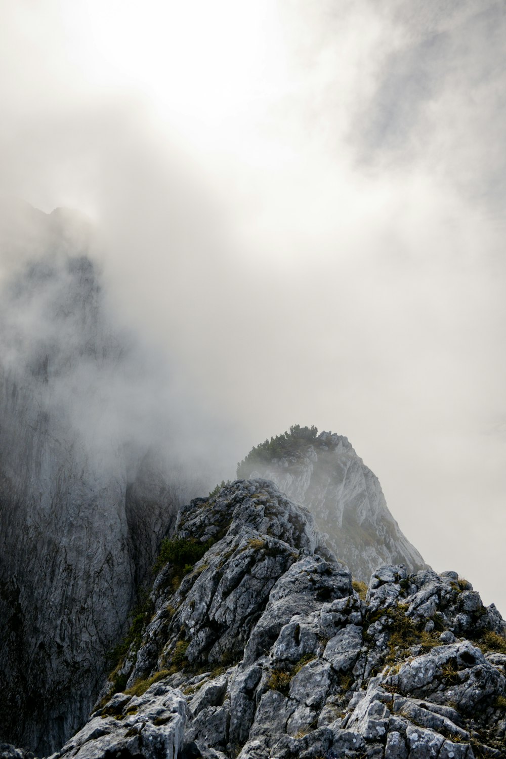 a rocky mountain with clouds