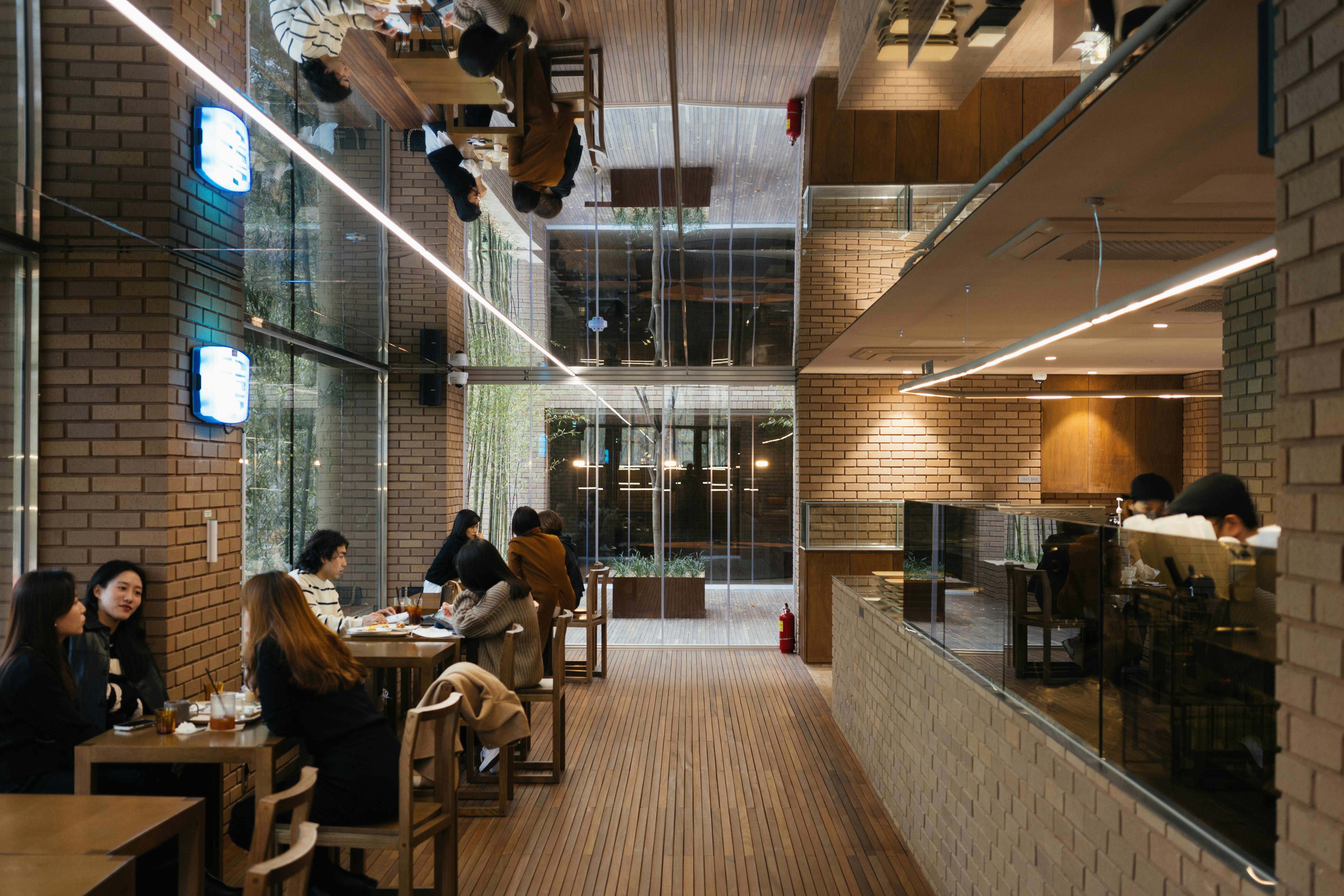 Group of people sitting at tables in a restaurant