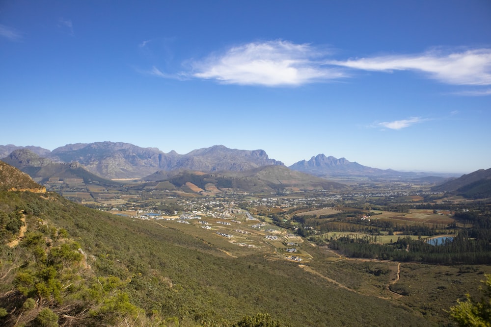 a valley with mountains in the background