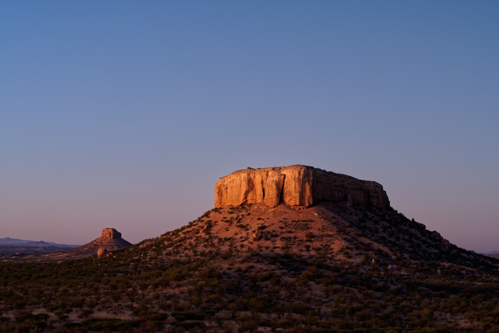 a large rock formation on a hill