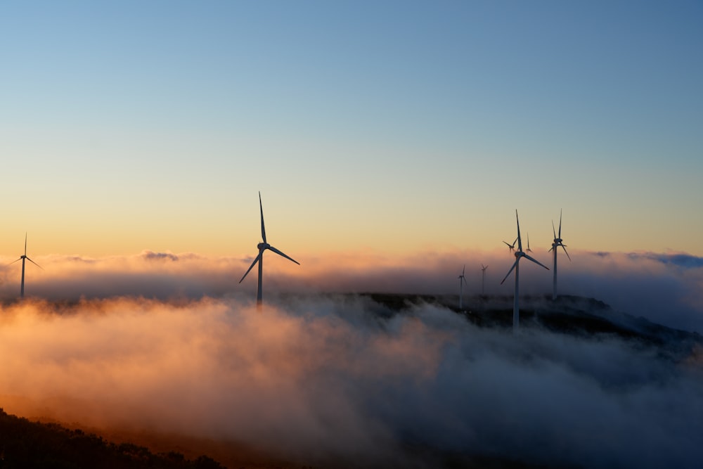 a group of wind turbines in the clouds