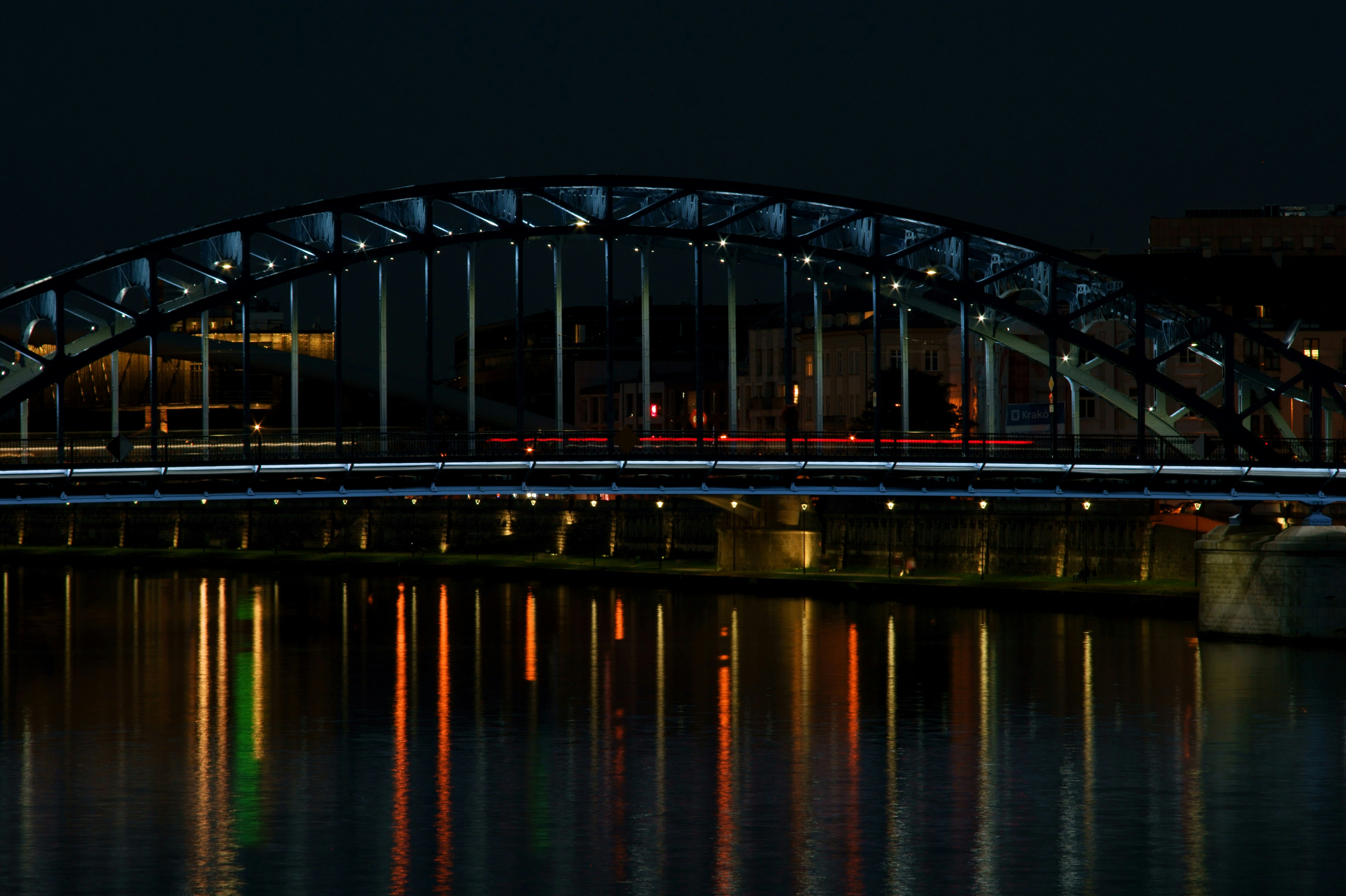 a bridge over water with a train on it